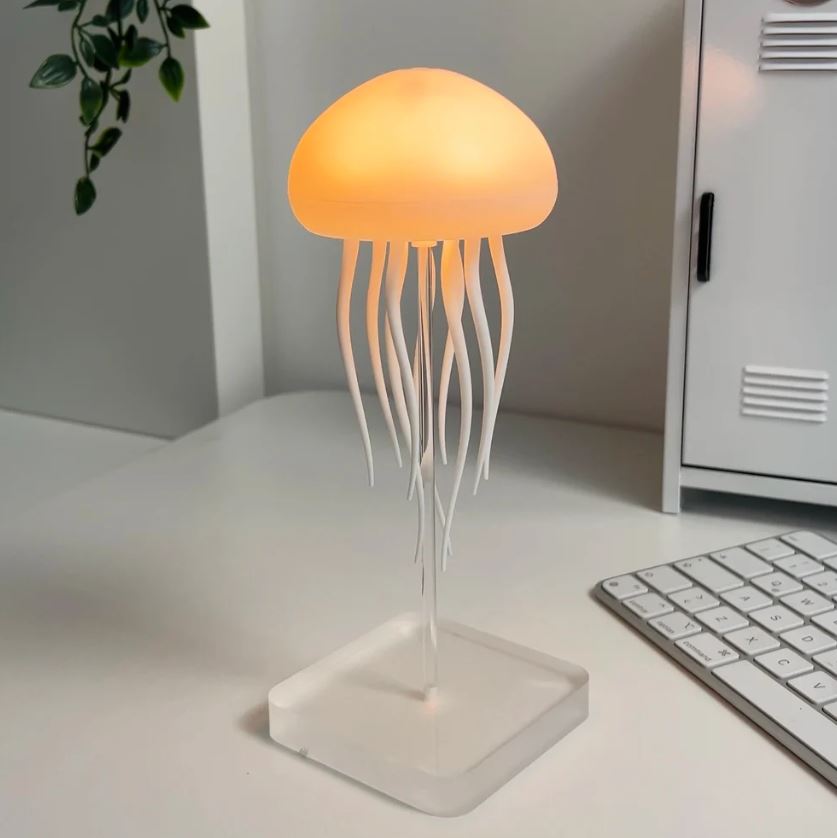 Mesmerizing jellyfish lamp creating a calming ambiance. Dynamic LED mood light, perfect for home decor & relaxation.
