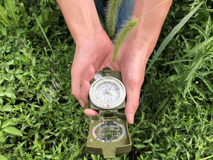 Rugged military compass with protective cover, ideal for outdoor survival and navigation.
