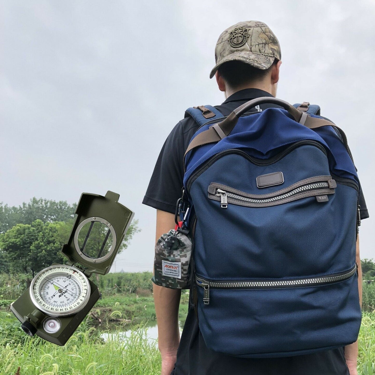 Black military-style lensatic compass, perfect for hiking, camping, and wilderness navigation.