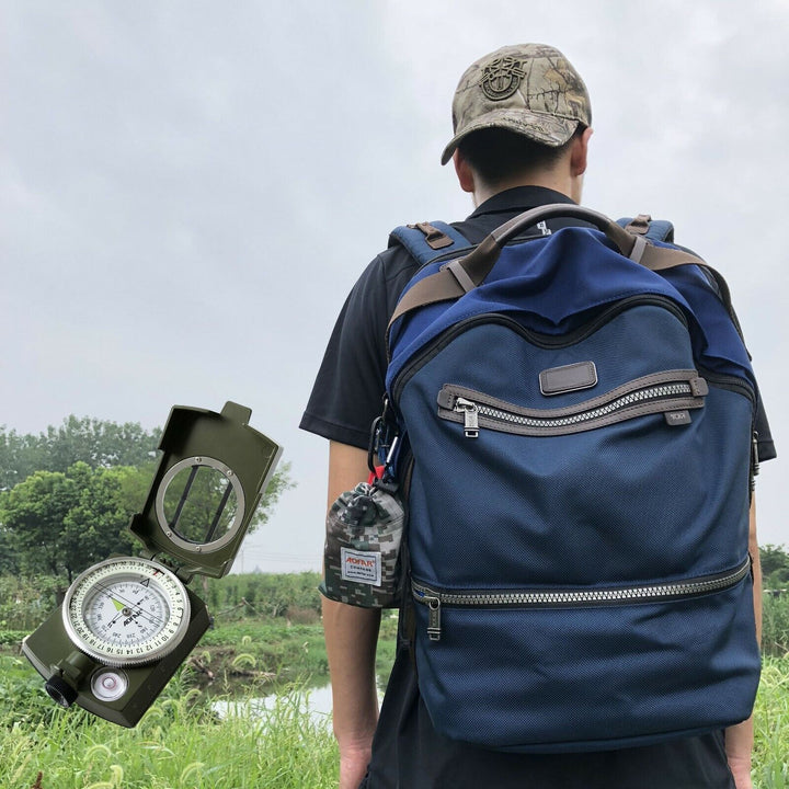 Black military-style lensatic compass, perfect for hiking, camping, and wilderness navigation.