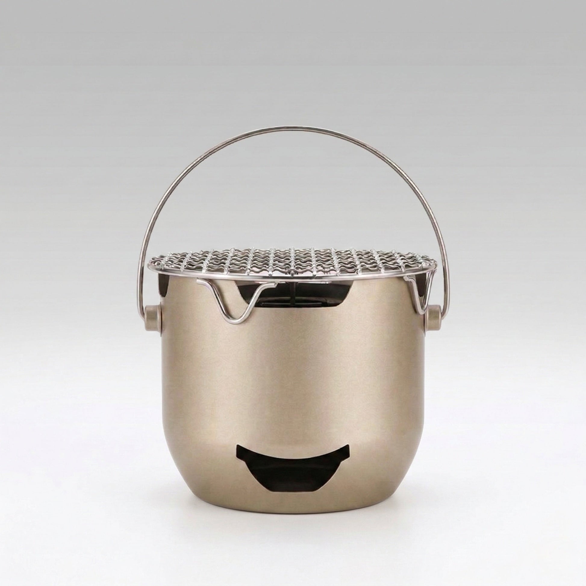 Mini cast iron charcoal grill, portable for camping and outdoor cooking, tabletop design for Korean BBQ.
