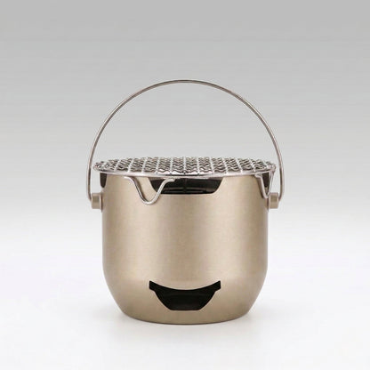 Mini cast iron charcoal grill, portable for camping and outdoor cooking, tabletop design for Korean BBQ.