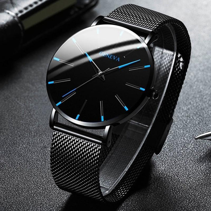 Sophisticated men's accessory: a minimalist watch with blue dial accents & black strap, an ideal gift for him.