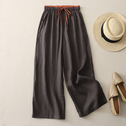 Stylish woman in flowy wide-leg trousers, perfect for summer style, beach vacations, or casual wear.