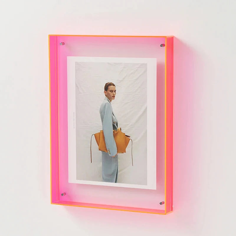 Modern floating photo frame, clear acrylic with bold, vibrant edge colors, perfect for stylish wall art.