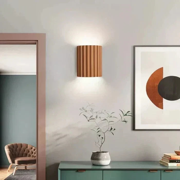 Decorative accent wall lamp featuring an elegant wave design. Modern lighting for unique interior spaces.