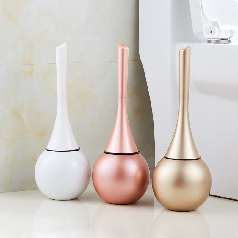 Stylish gold & silver toilet brush, modern design with durable flexible silicone head for bathroom hygiene.