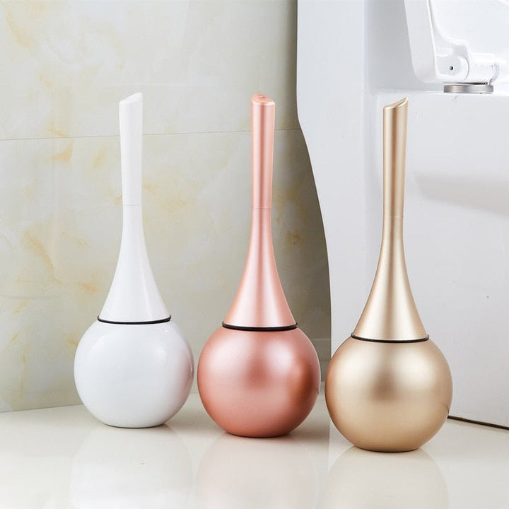 Stylish gold & silver toilet brush, modern design with durable flexible silicone head for bathroom hygiene.