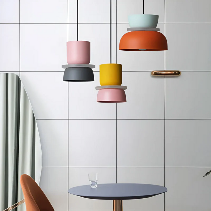 Macaron LED pendant light illuminating a modern living space, colorful & stylish ceiling fixture.