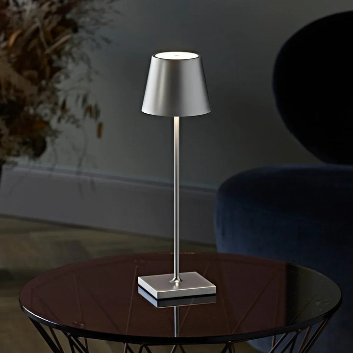 Long slender modern dimmable table lamp, LED, rechargeable aluminum design for desks or bedside.