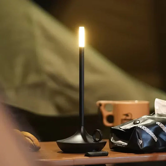 Modern dimmable rechargeable LED candle table lamp. Portable wireless ambient light for home decor.