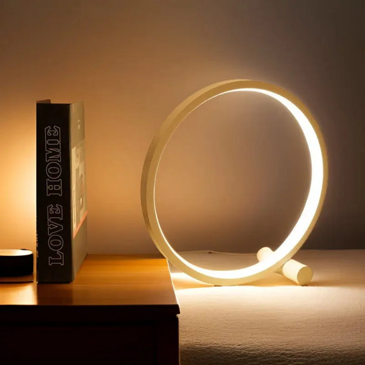 Black LumaCircle minimalist LED table lamp, dimmable for adjustable light, ideal for modern home decor.
