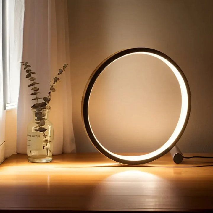 White LumaCircle energy-efficient LED night lamp, dimmable for soft ambient bedroom or office lighting.
