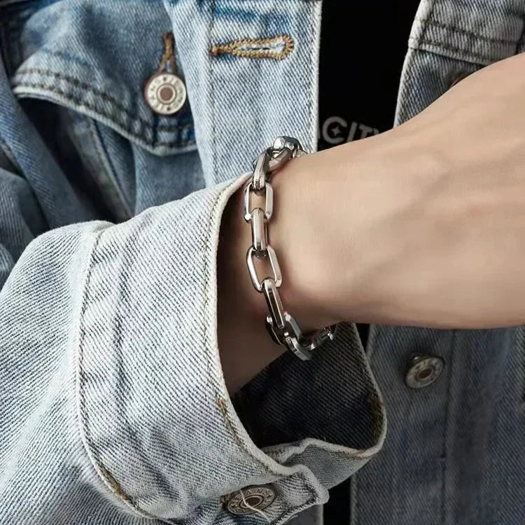 Polished men's stainless steel chain bracelet, modern design with interlocking rectangular links. A versatile accessory.