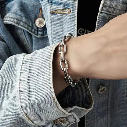 Polished men's stainless steel chain bracelet, modern design with interlocking rectangular links. A versatile accessory.