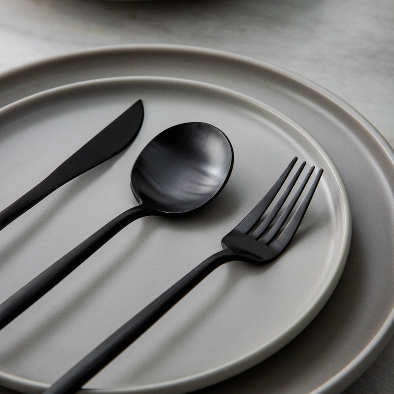 Matte silver flatware set beautifully arranged for a modern minimalist table.