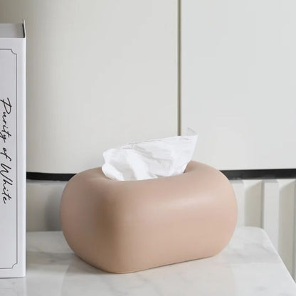 Sleek ceramic tissue box cover on a bathroom vanity, a modern and neutral accessory for bath decor.