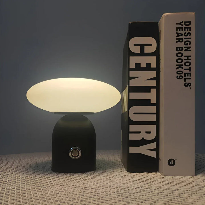 Sleek black rechargeable mushroom LED lamp, a modern wireless table light with smart touch for ambiance.
