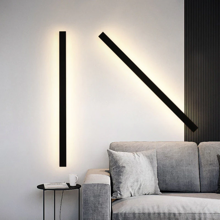 Bright LineaGlow LED wall lamp illuminating a modern outdoor living space at night.