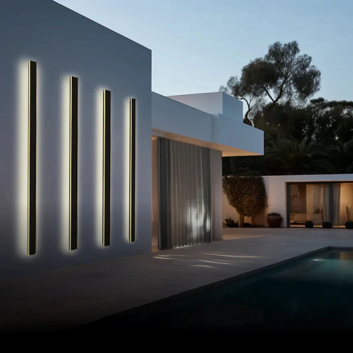 LineaGlow modern LED wall lamp, casting a soft glow on a contemporary facade.
