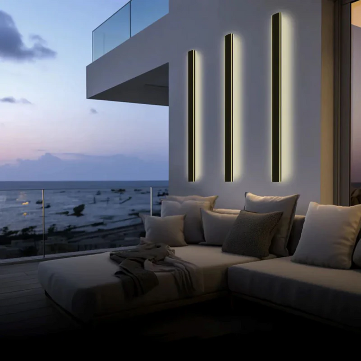 Sleek LineaGlow outdoor LED wall lamp, enhancing a modern patio with warm light.
