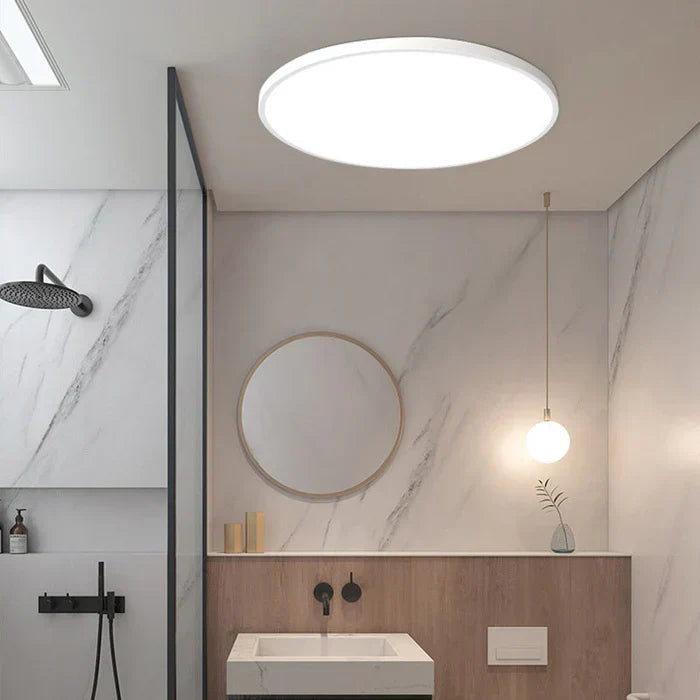 Energy-efficient round LED ceiling light, ideal for contemporary living room or bedroom decor.