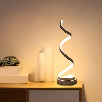 Modern spiral LED table lamp with dimmable light for ambient home decor.