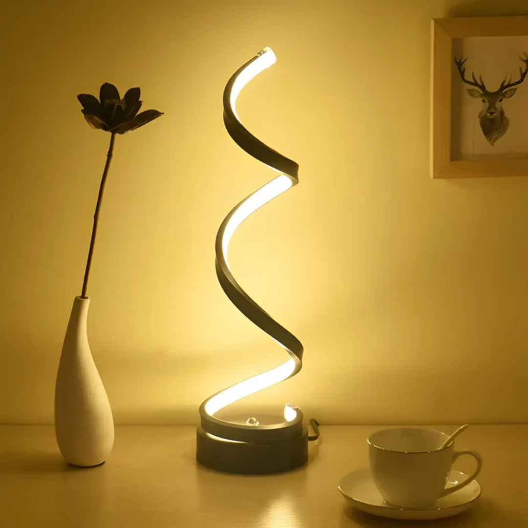 White modern spiral LED desk lamp, dimmable for eye comfort and energy-efficient ambient lighting.