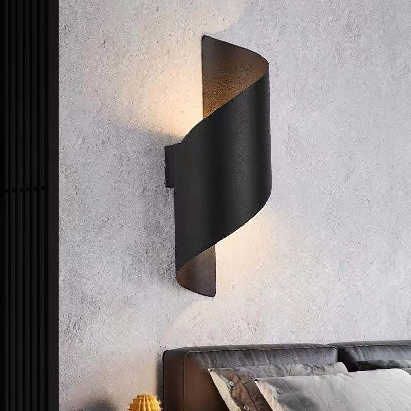 Artful spiral LED wall light providing energy-efficient illumination for modern homes.
