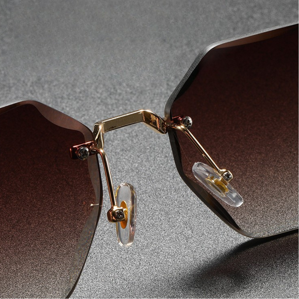 Fashionable unisex octagonal sunglasses; sleek rimless design, comfortable eyewear.