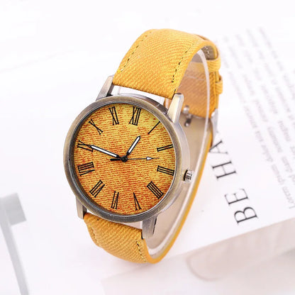 Side view of a unisex denim watch, highlighting the bronze case and the texture of the durable denim strap. Streetwear.