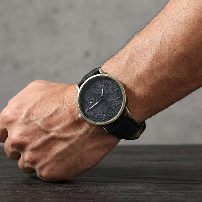 Close-up of a modern unisex Tokyo denim watch showing its unique denim strap texture and polished bronze case.