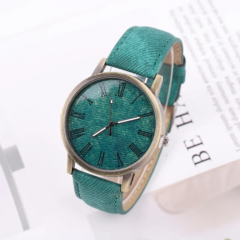 Front view of a unisex denim watch with a bronze case, showcasing its minimalist dial and Tokyo street style vibe.