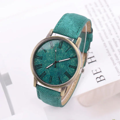 Front view of a unisex denim watch with a bronze case, showcasing its minimalist dial and Tokyo street style vibe.