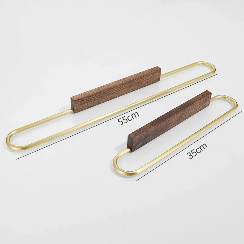 Sleek walnut wood towel bar, modern design with elegant brass accents, enhances any bathroom decor.