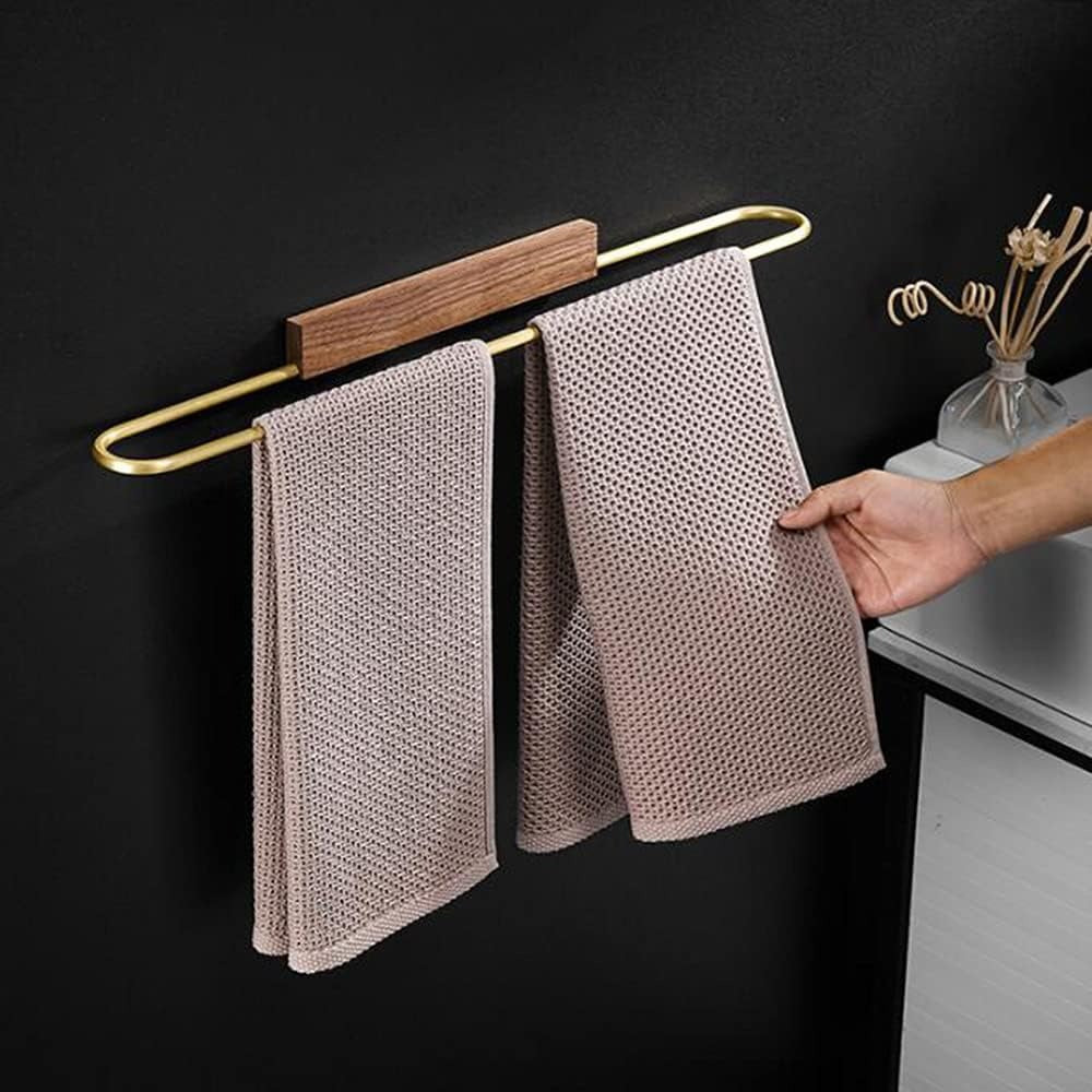 Contemporary walnut towel bar with brass accents, a stylish wall-mounted solution for bathroom organization.