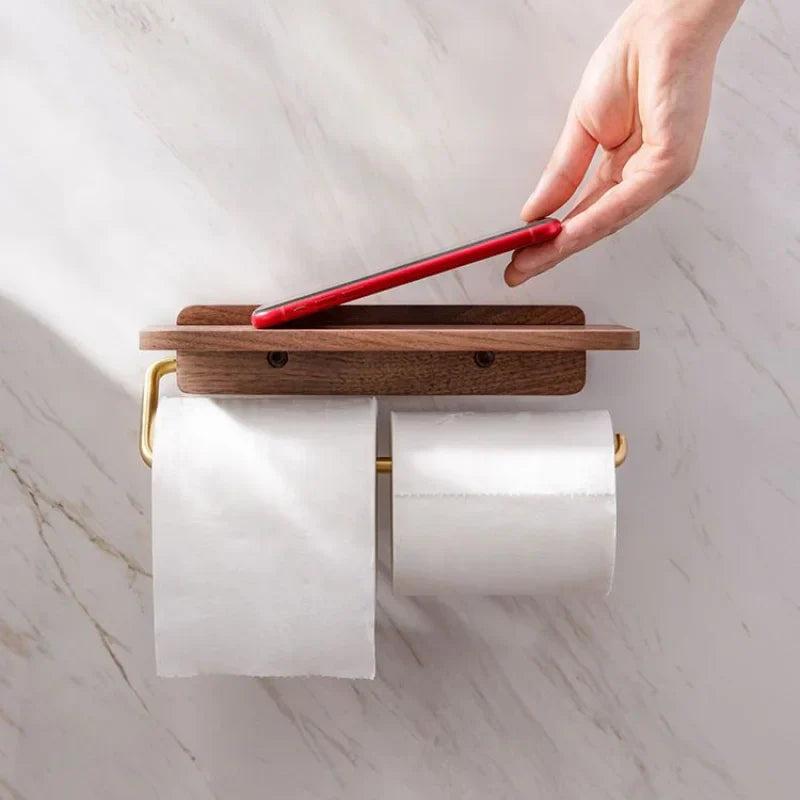 Modern wall-mounted toilet paper holder with practical walnut wood shelf for bathroom storage.