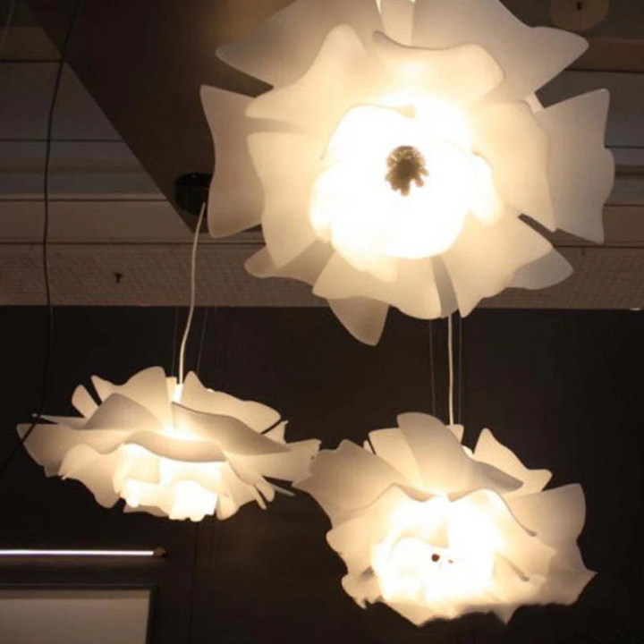 Bright white metal flower pendant lamp. Creates a warm glow, modern lighting for comfortable living.