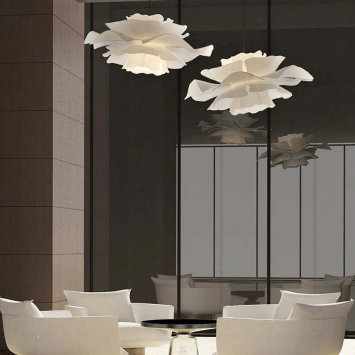 Contemporary white metal flower pendant lamp. Stylish home decor, modern lighting statement piece.