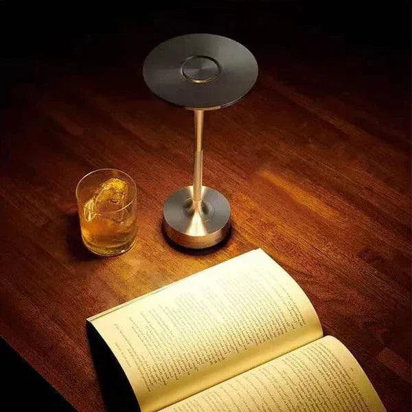 Dimmable LED desk lamp creating warm ambiance. Rechargeable wireless table light, perfect for reading or relaxation.