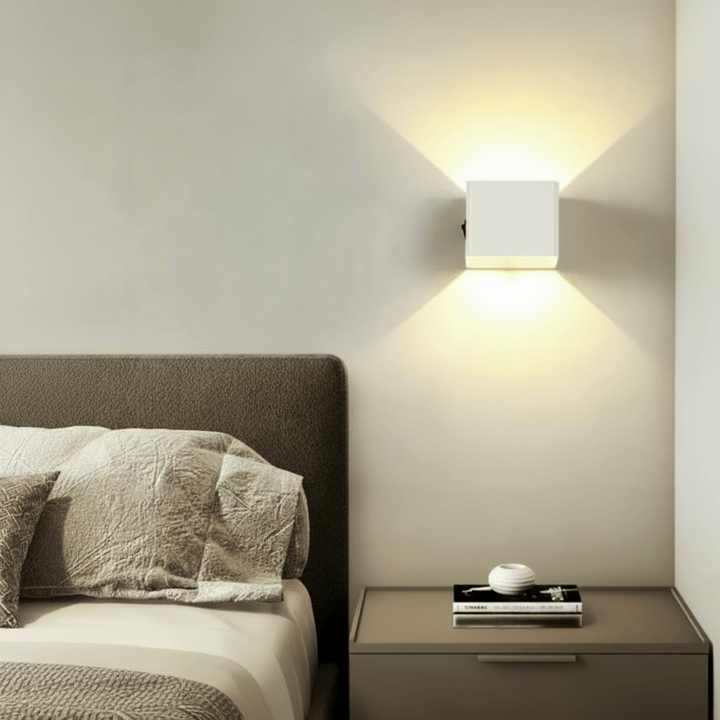 Adjustable beam LED wall light, wireless and contemporary, creating ambient interior lighting.