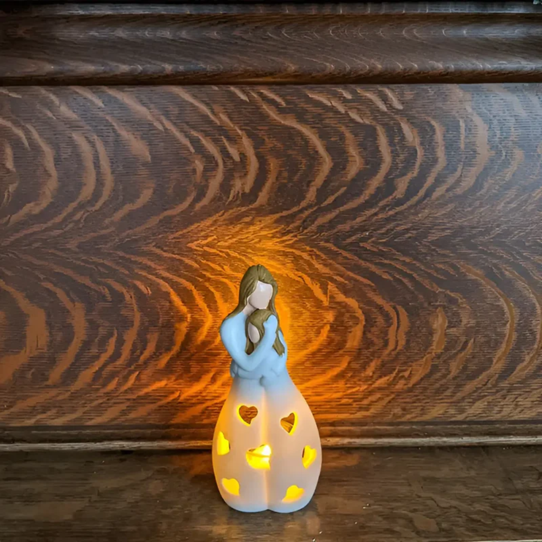 Mother daughter embracing candle holder, a sentimental home decor piece representing eternal family love.