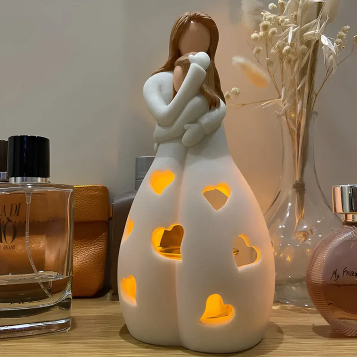 Sentimental candle holder featuring a mother and daughter embrace, a beautiful and unique home decor gift.