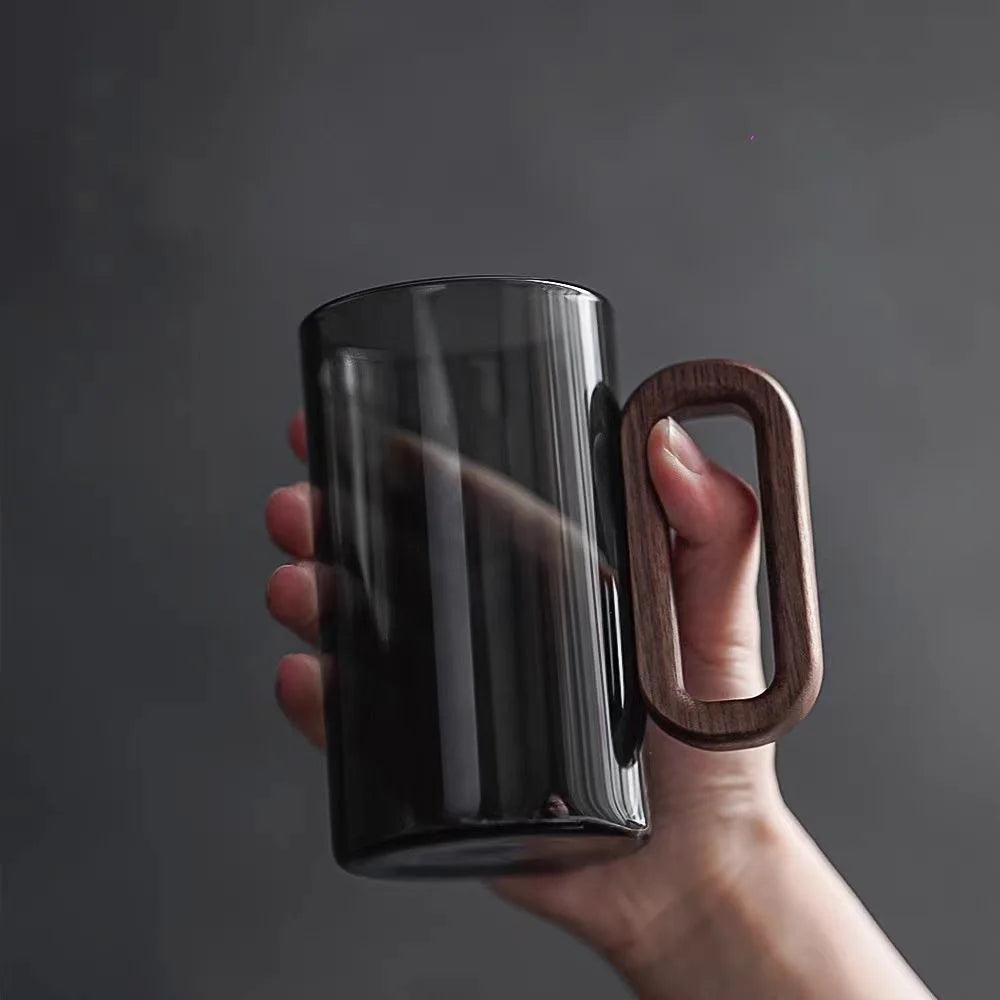 Clear glass coffee mug with mountain base. Perfect for tea, coffee, and home decor. Unique kitchenware gift.