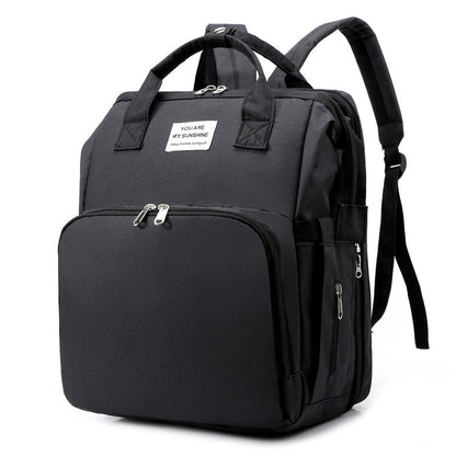 Multi-function portable baby bed & diaper bag travel backpack for parents on the go.