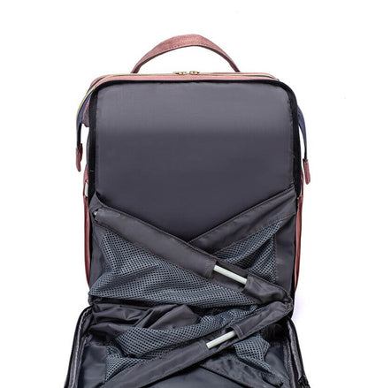 Interior view of multi-compartment nappy bag & travel backpack with portable bed.