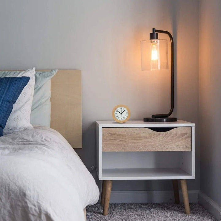Close-up of natural wood digital alarm clock. Modern minimalist design with clear silent display for bedroom decor.