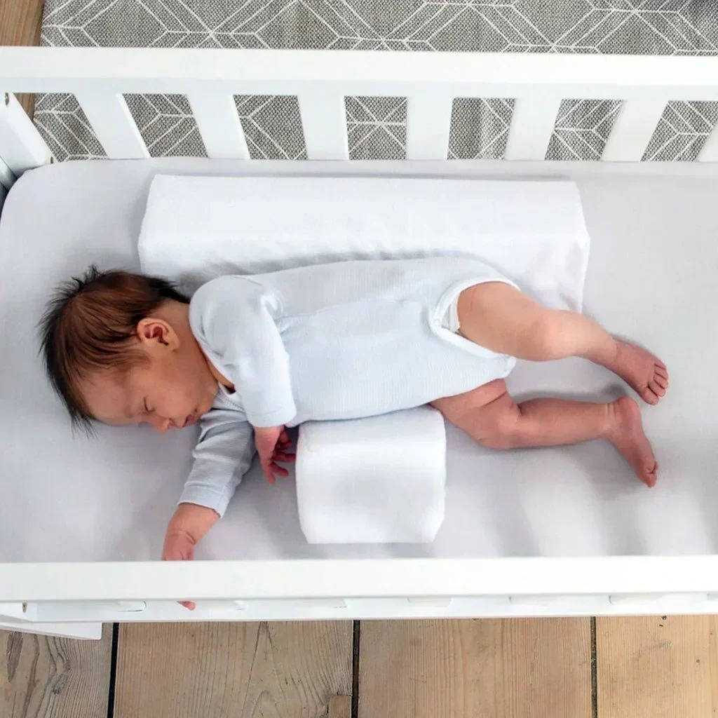 Baby side sleeper wedge offers reflux support & comfort for newborns, an essential infant positioner.