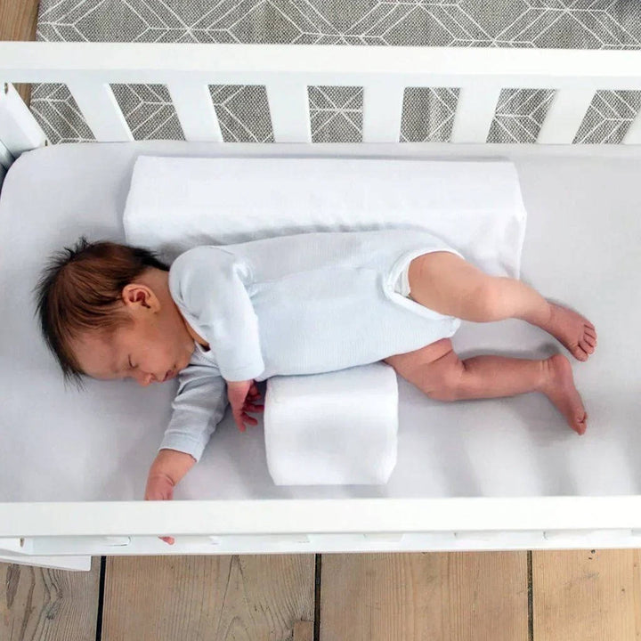 Baby side sleeper wedge offers reflux support & comfort for newborns, an essential infant positioner.