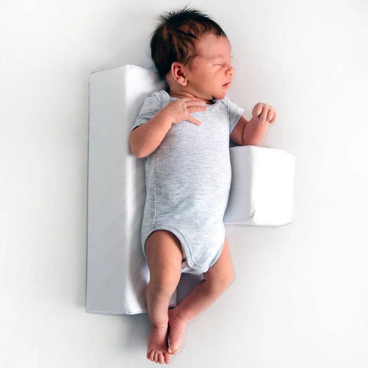 Infant sleep positioner wedge with reflux support for safe newborn sleep and improved head shape.
